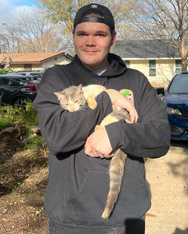 Man holding a kitten with cerebellar hypoplasia - The Seven Freedoms- Promises We Must Make Now to Protect Pets